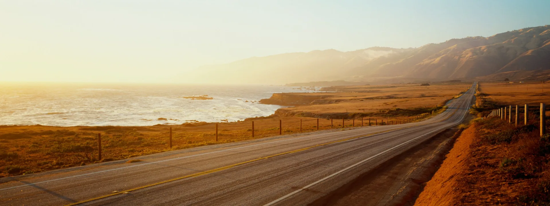 Coastal highway at sunset beside the Pacific Ocean, banner for anxiety therapy by telehealth