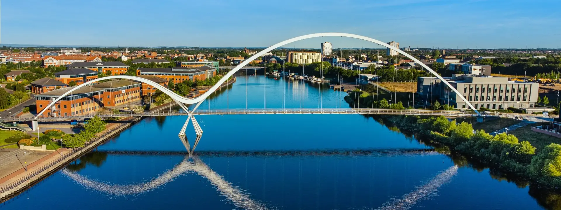White arch footbridge over a calm river, banner for personality disorder therapy by telehealth
